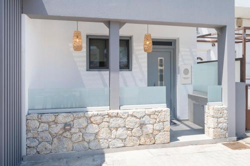 a facade of a building with a stone wall at Luxury studio Thomas & Irini in Kos Town