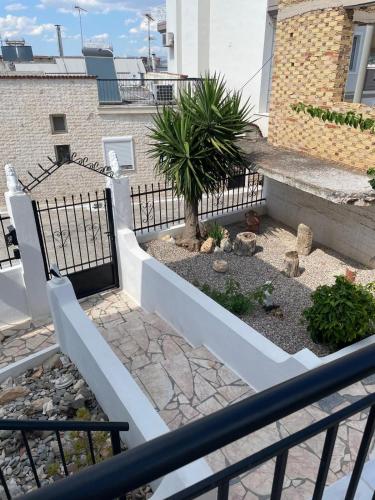 a stairway with a fence and a plant at The White House - Aianteio in Aiándion