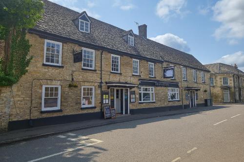 a large brick building on the side of a street at The Swan Hotel Oxford in Eynsham