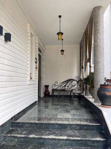 a hallway with a bench on a porch at Korca Center Apartment in Korçë