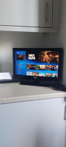 a flat screen tv sitting on top of a counter at spacious self-contained accommodation 135 cantebury road Herne bay CT6 5RZ in Kent