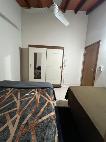 a bedroom with two beds and a mirror at Casa de 2 habitaciones y 4 camas in Barrio San Isidro (2)