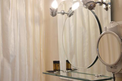 a bathroom with a mirror and a shower curtain at Art Pythia Boutique in Delphi