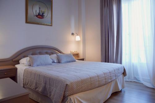 a bedroom with a bed in a room with a window at Art Pythia Boutique in Delphi