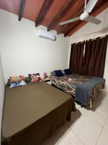 two beds in a room with a ceiling at Casa de 2 habitaciones y 4 camas in Barrio San Isidro (2)