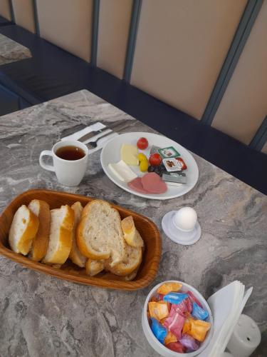a table with a plate of bread and a cup of coffee at Otel Yenikapı in Istanbul