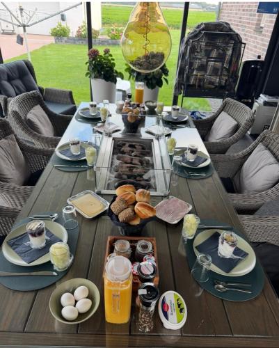 a wooden table with breakfast food on it at NextDay in Erica
