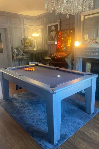 a pool table with balls on top of it in a room at Room to rent for Oasis in Middleton