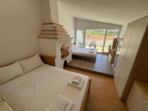 a small room with a bed and a fireplace at Apartments Valentino by Pag tours in Pag