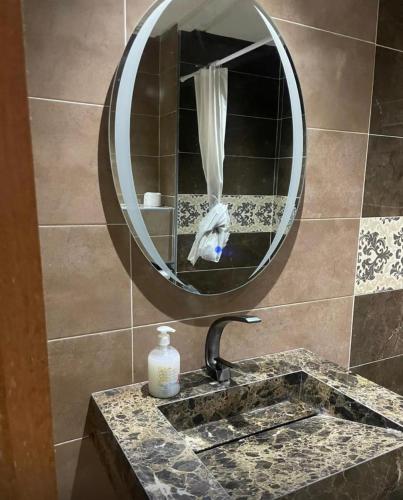 a bathroom with a sink and a mirror at Ola Blanca in Dar Hamida