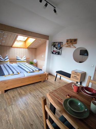a bedroom with a large bed and a table at Ferienwohnung Claire in Bad Kohlgrub