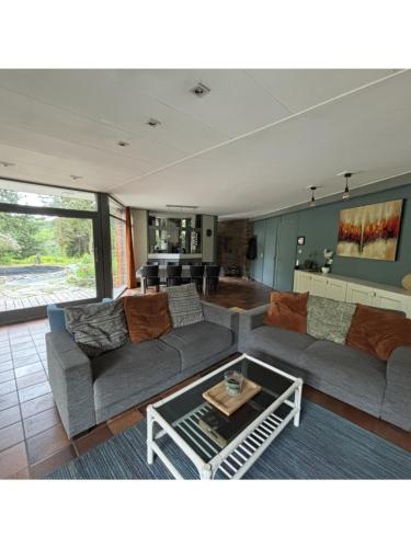 a living room with a couch and a table at Domaine Heyen in Waimes
