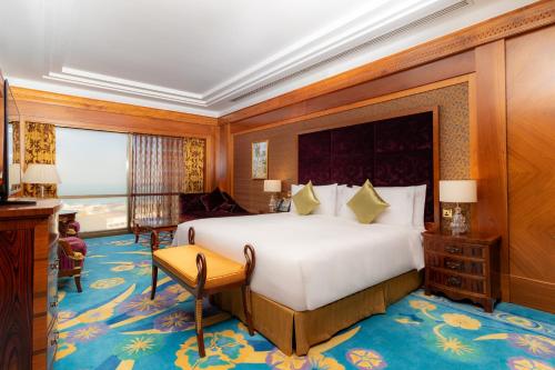 a bedroom with a large bed in a room at Holiday Inn - Suites Kuwait Salmiya by IHG in Kuwait