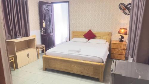a small bedroom with a bed and a window at Bao Long Hotel in Ho Chi Minh City