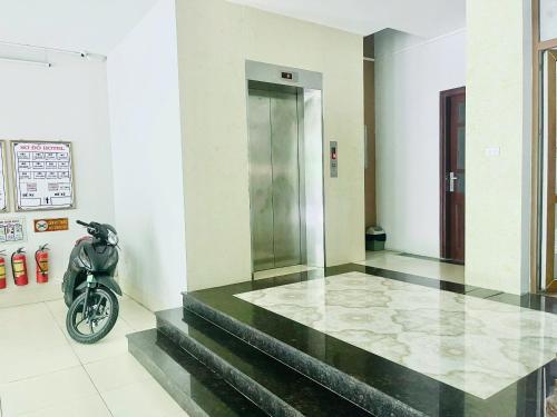 a motorcycle parked in a room with a lobby at Hotel Hoà Bình Riverside Văn Phú in Hà Ðông