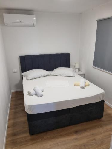 a bedroom with a large bed with white sheets at Villa Mila in Bol