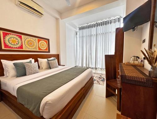 a bedroom with a large bed and a window at 360 Viewpoint by Queens Mount in Kandy