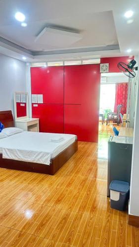 a bedroom with a bed with a red wall at Bao Long Hotel in Ho Chi Minh City
