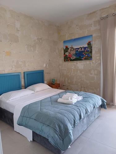 a bedroom with a large bed with towels on it at GREEN FRESH in Trapani