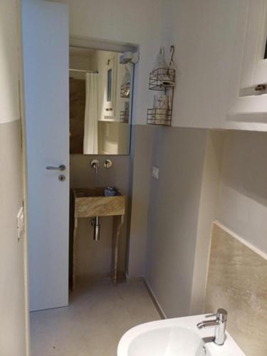a small bathroom with a sink and a toilet at GREEN FRESH in Trapani