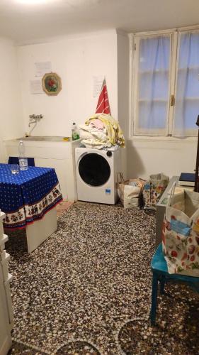 a kitchen with a microwave in the corner of a room at Hostello Genovese in Genova