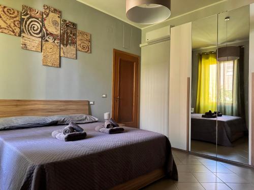 a bedroom with a bed with two towels on it at casa Martina - LuxRental Apartments in Pescara