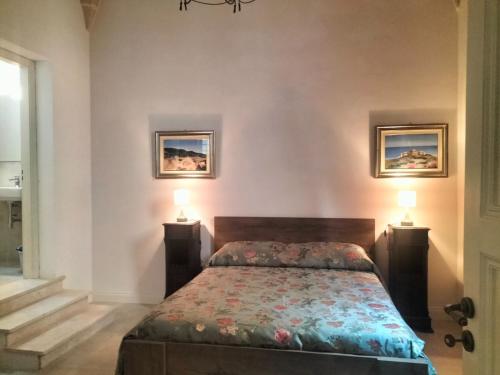 a bedroom with a bed with two lamps on it at Piazza Vittorio 30 in Trapani