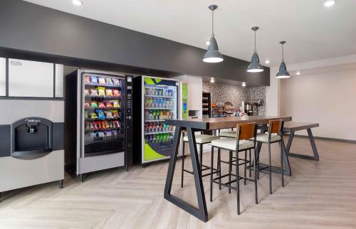a drink station with a bar and a refrigerator at Extended Stay America Premier Suites - Bradenton in Bradenton