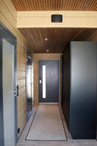 a hallway with two elevators and a door at Levin Lyhty Bella by Hilla Villas in Kittilä