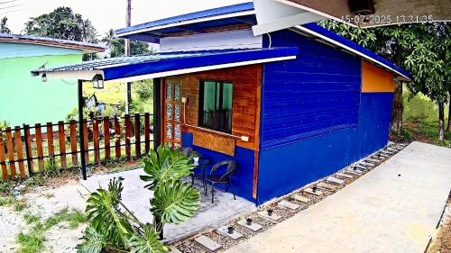 a blue house with a fence in front of it at Lamai home 4 in Ko Yao Noi