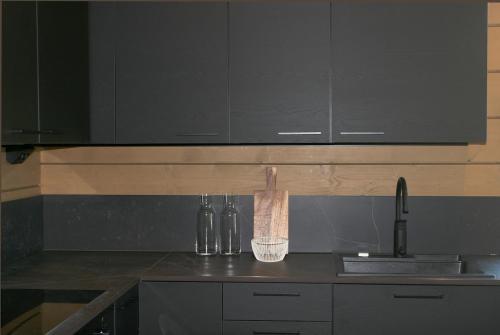 a kitchen with a counter top with a sink at Levin Lyhty Bella by Hilla Villas in Kittilä