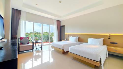 Ένα ή περισσότερα κρεβάτια σε δωμάτιο στο Prima Hotel Pattaya