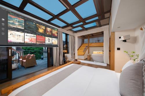 a bedroom with a bed and a large window at Chongqing Xiannv Mount Peach Blossom Spring Homest in Wulong