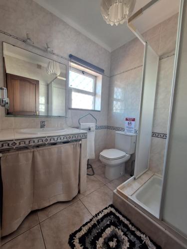 a bathroom with a tub and a toilet and a shower at Casa da torre in Luz de Tavira