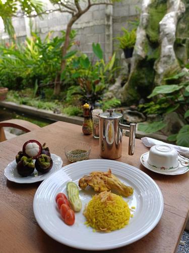 a wooden table with plates of food on it at Baan Debtida in Bangkok