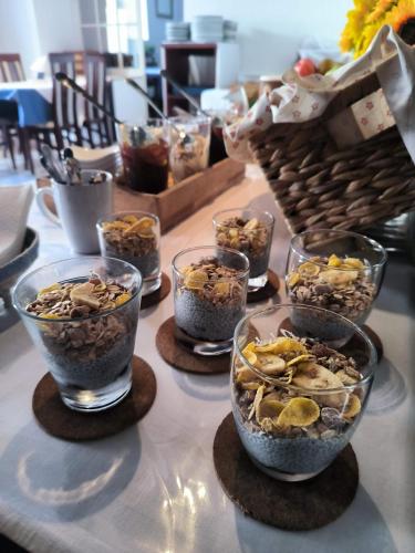a table topped with bowls of food and a basket at Omir Bed & Breakfast in Pula