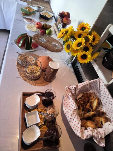 a table with a bunch of food and flowers on it at Omir Bed & Breakfast in Pula