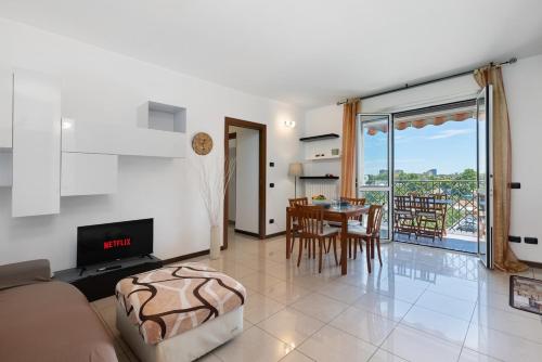 a living room with a couch and a table at Elegant Terrace Flat Parking near Rho Fiera Mi in Milan