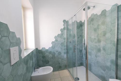 a bathroom with a shower and a toilet and a sink at Casa Vacanze Villa Francesca in Peschici