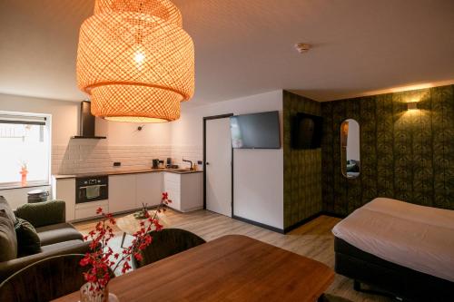a living room with a table and a kitchen at Hotel Walram in Valkenburg