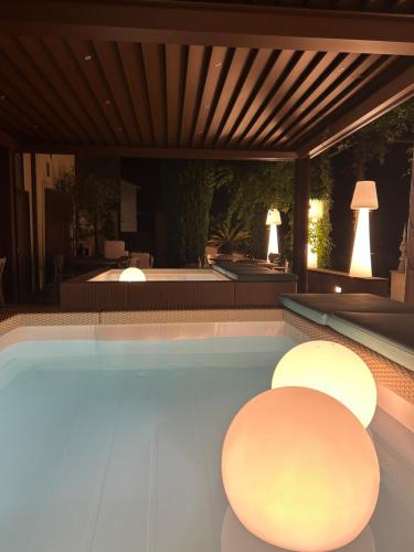 a swimming pool with two circular lights in a house at Palazzo Bontadosi Hotel & Spa in Montefalco