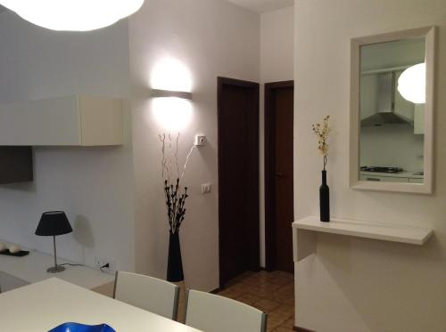 a kitchen with a table and chairs and a mirror at Le Stanze di Theia in Chianciano Terme