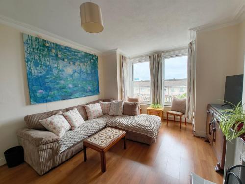 a living room with a couch and a table at Gorgeous Gorleston holiday home in Gorleston-on-Sea