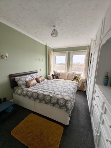 a bedroom with a large bed and a window at Gorgeous Gorleston holiday home in Gorleston-on-Sea