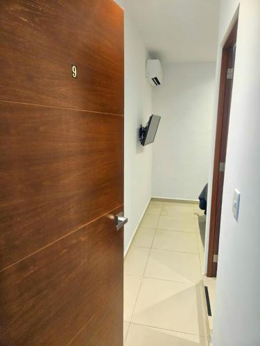 a wooden door in a room with a hallway at Villa Leo in Cancún