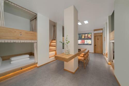 a room with a bed and a table and chairs at Chongqing Xiannv Mount Peach Blossom Spring Homest in Wulong