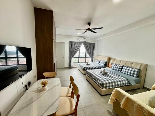 a living room with two beds and a flat screen tv at Dreamy Sunsuria Forum Homes-Setia City Mall, Setia City Convention Centre and National Institute of Health in Shah Alam