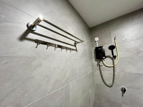 a shower in a bathroom with a shower head at Dreamy Sunsuria Forum Homes-Setia City Mall, Setia City Convention Centre and National Institute of Health in Shah Alam