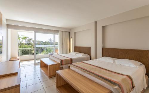 une chambre d'hôtel avec deux lits et un balcon dans l'établissement Rio Quente Cristal Resorts, à Rio Quente