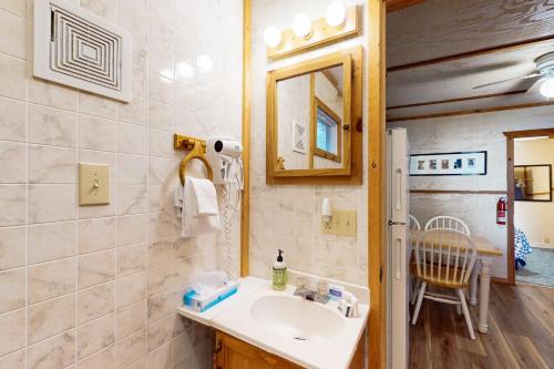 a bathroom with a sink and a mirror at Catfish Cottage B in Eagle River